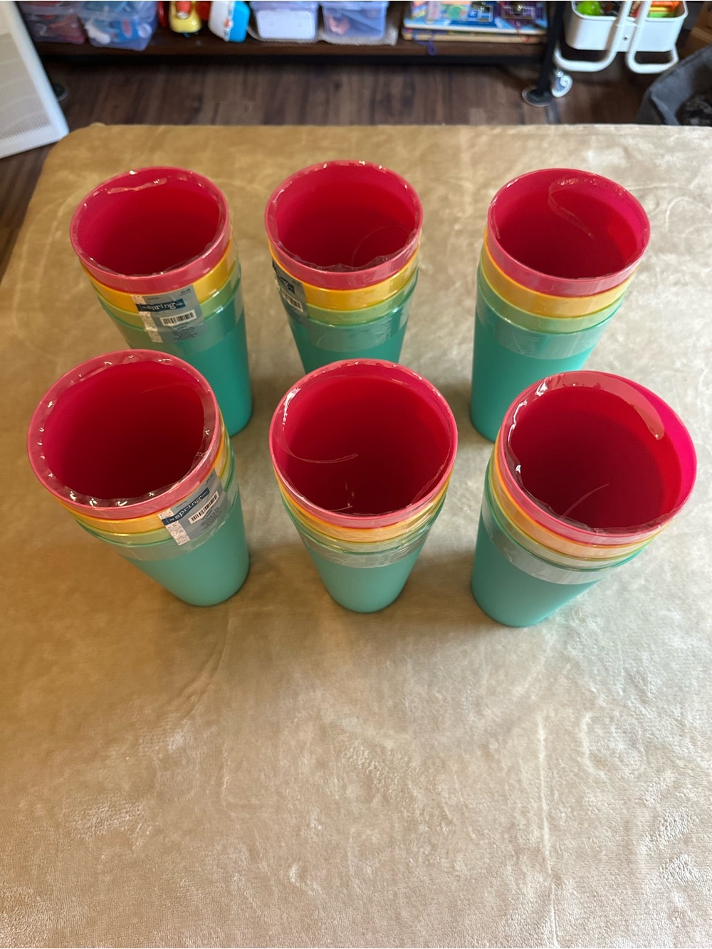 24 reusable cups in pink, green, blue, and yellow.